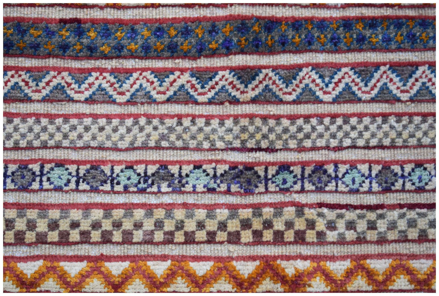 Handmade Afghan Yekta runner featuring horizontal bands of geometric patterns in wool.