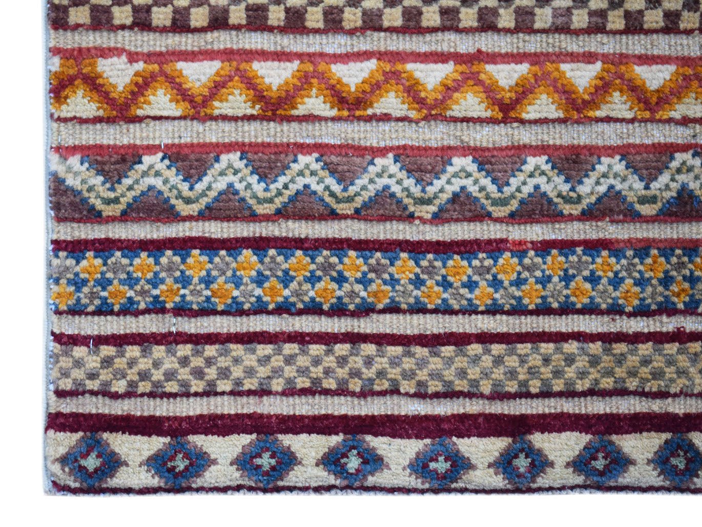 Handmade Afghan Yekta runner rug featuring horizontal bands of geometric and tribal patterns.
