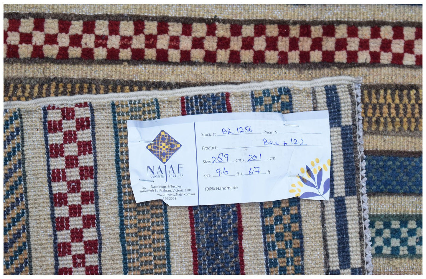 A handmade Afghan Yekta rug featuring a geometric pattern with red and blue checkered borders.