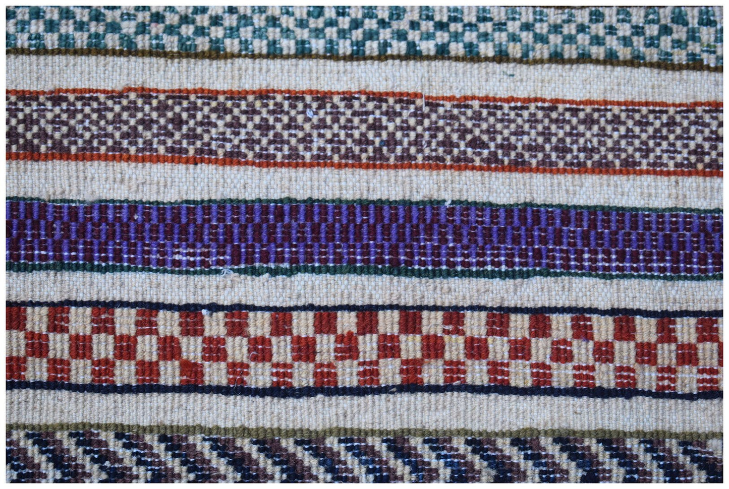 A handmade Afghan Yekta rug featuring horizontal bands of colorful geometric and checkered patterns.