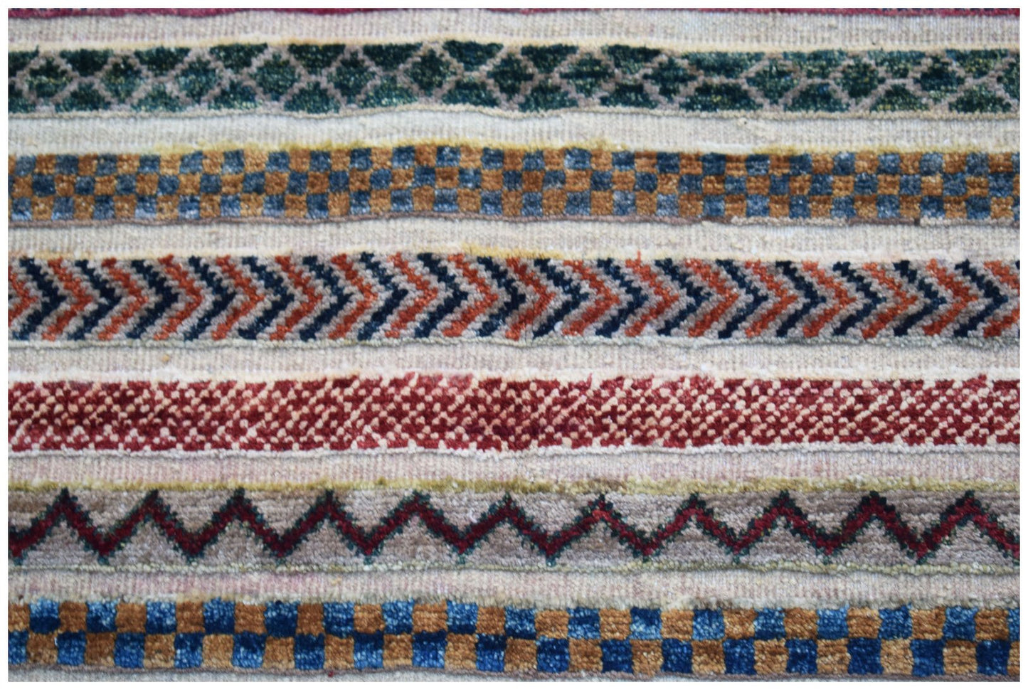 Handmade Afghan Yekta rug featuring horizontal bands of geometric patterns in wool.
