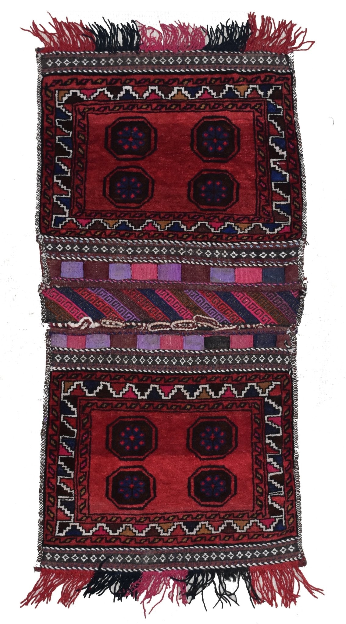 A handmade vintage Afghan wool saddle bag featuring two red panels with geometric motifs.