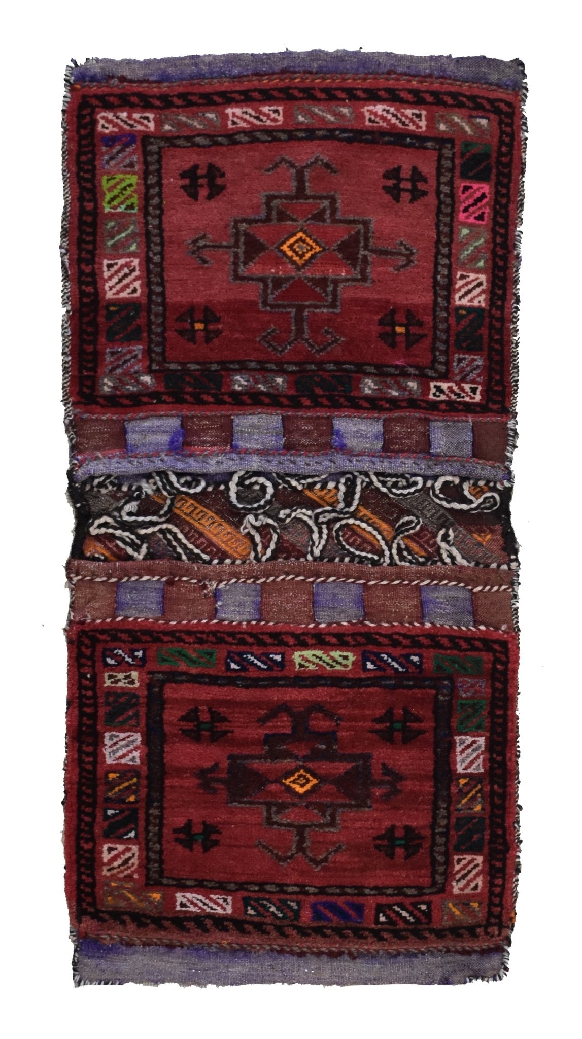 A handmade vintage Afghan wool saddle bag featuring two red panels with geometric tribal motifs.