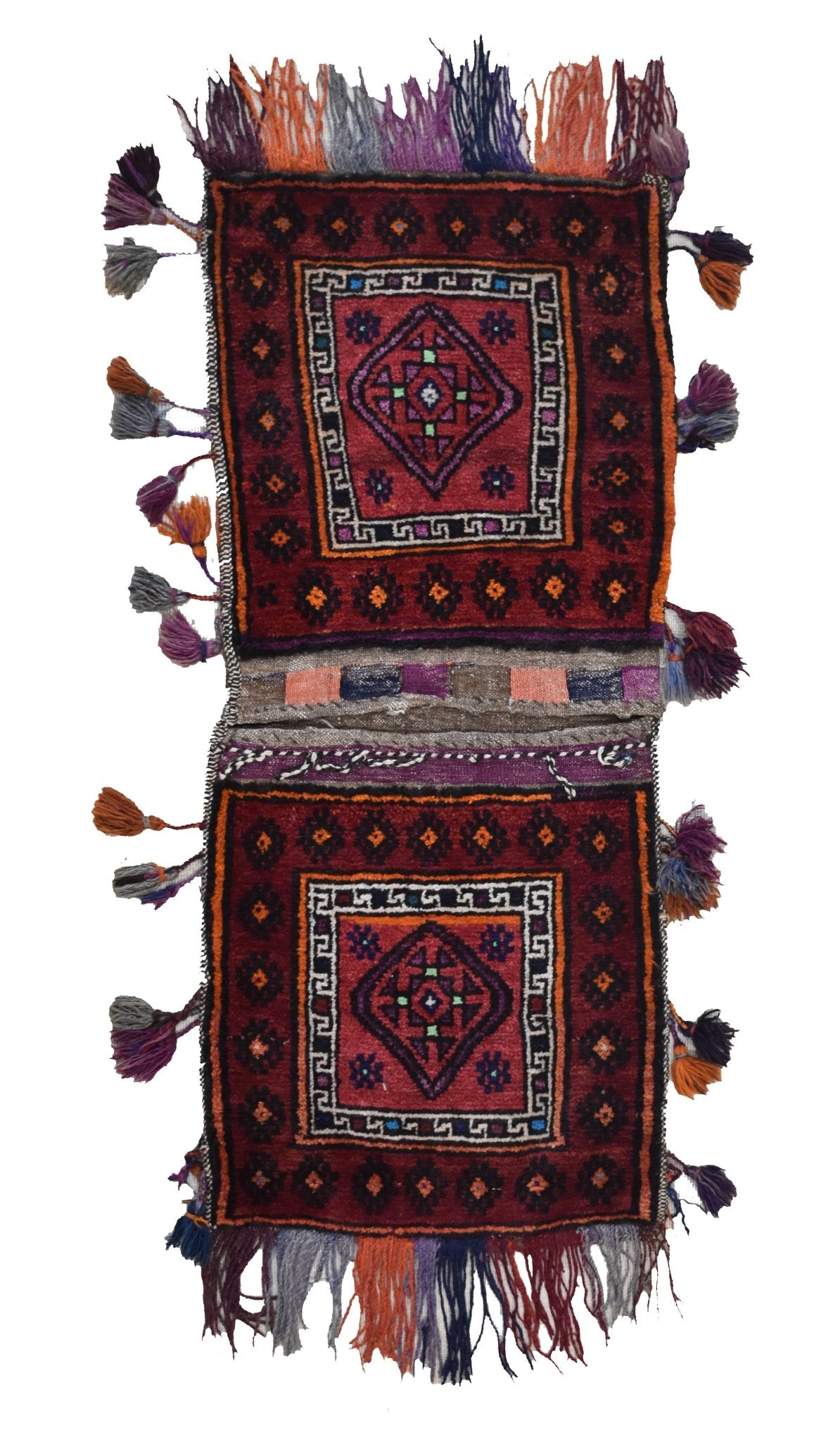 A handmade vintage Afghan wool saddle bag featuring two red panels with geometric tribal patterns.