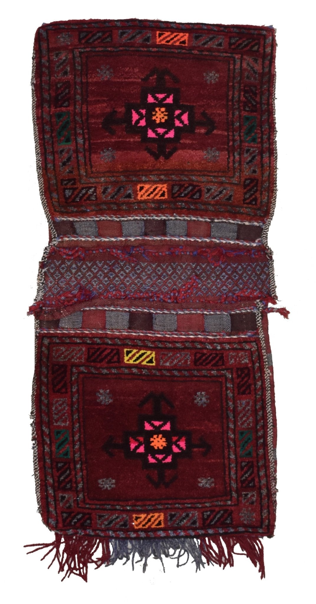 A vintage handmade Afghan wool saddle bag featuring two matching red panels with geometric motifs.