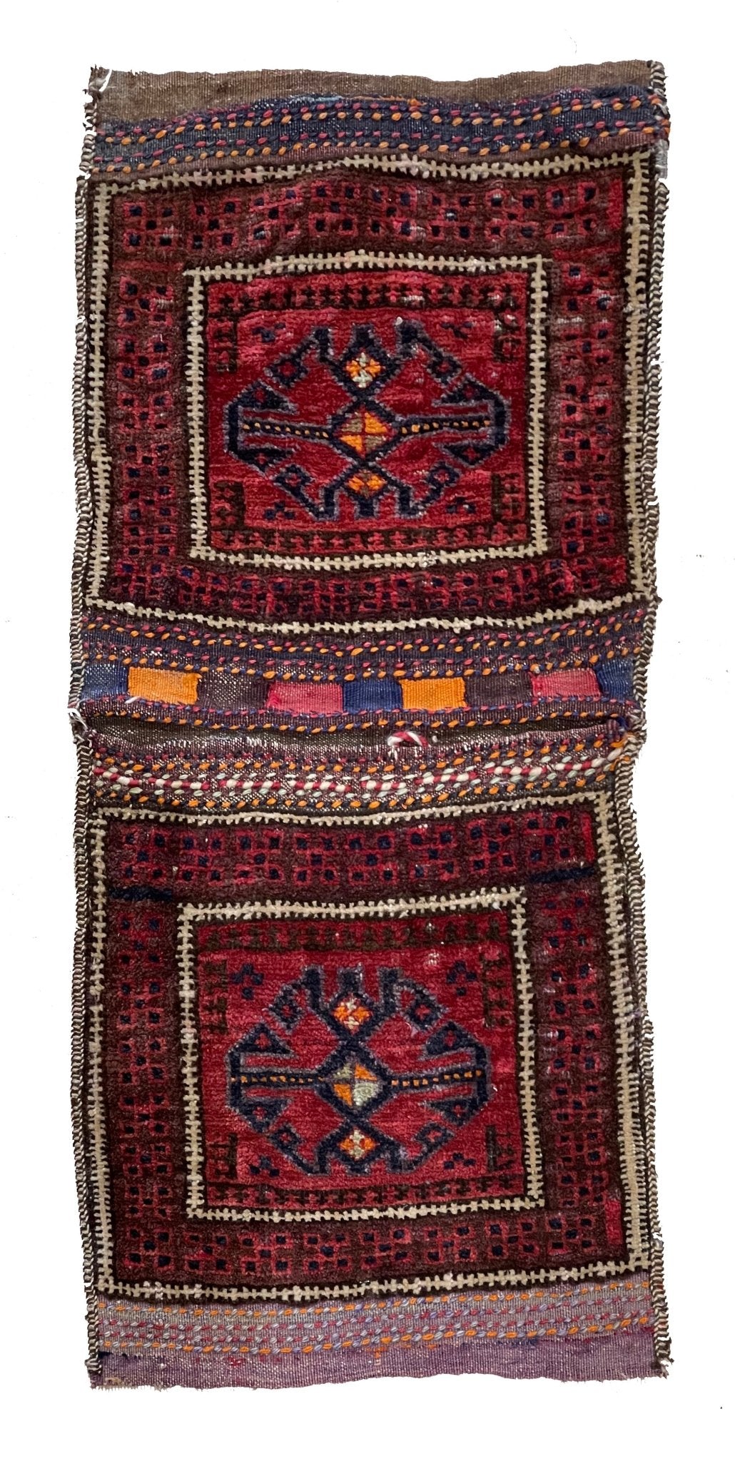 A vintage handmade Afghan wool saddle bag featuring two square panels with geometric motifs.