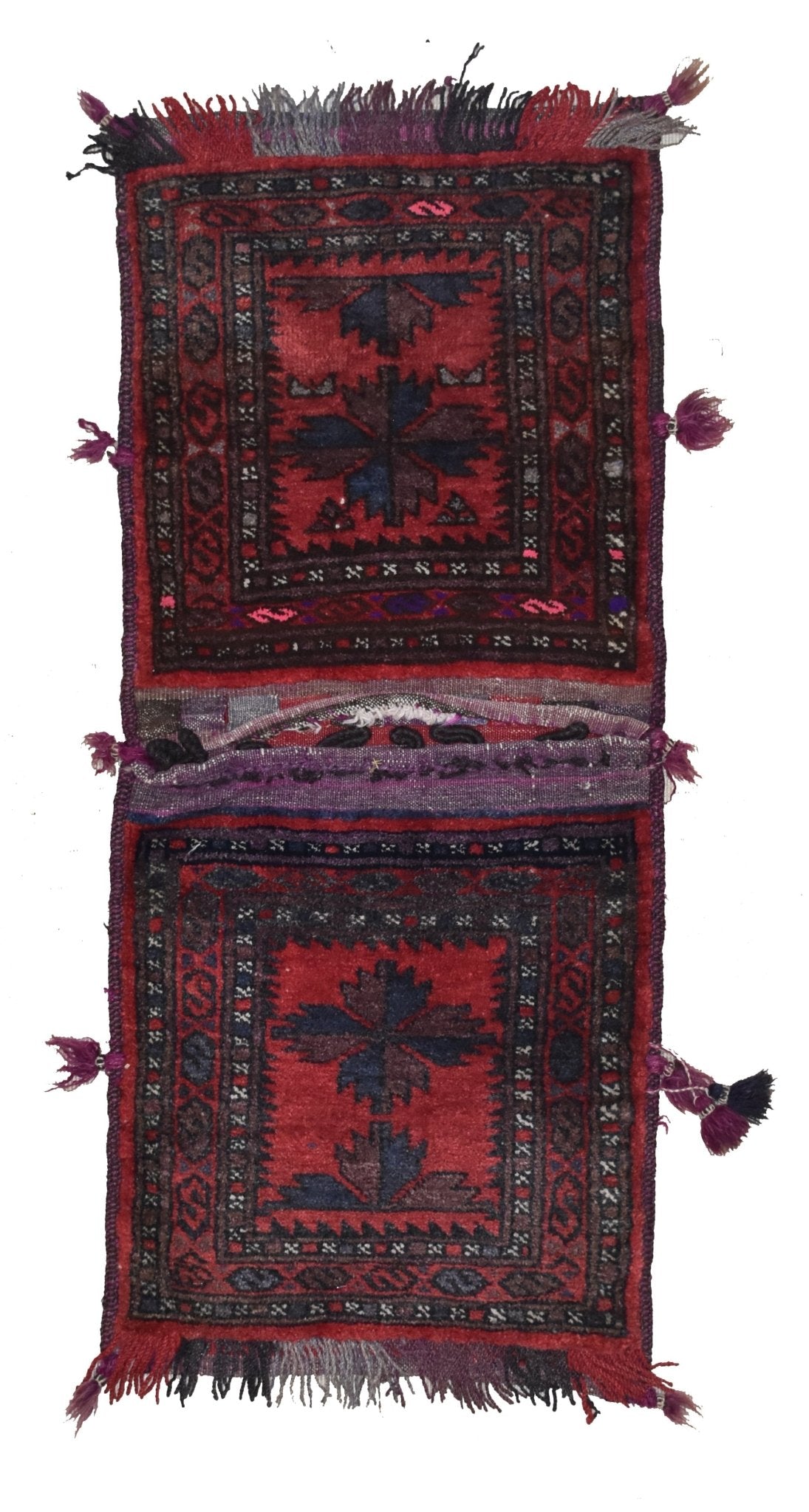 A vintage handmade Afghan wool saddle bag featuring two matching red panels with geometric motifs.
