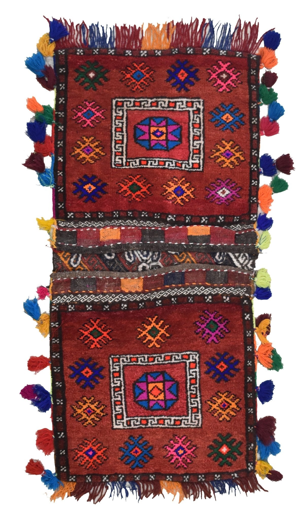 A handmade vintage Afghan wool saddle bag featuring two square panels with geometric motifs and colorful tassels.