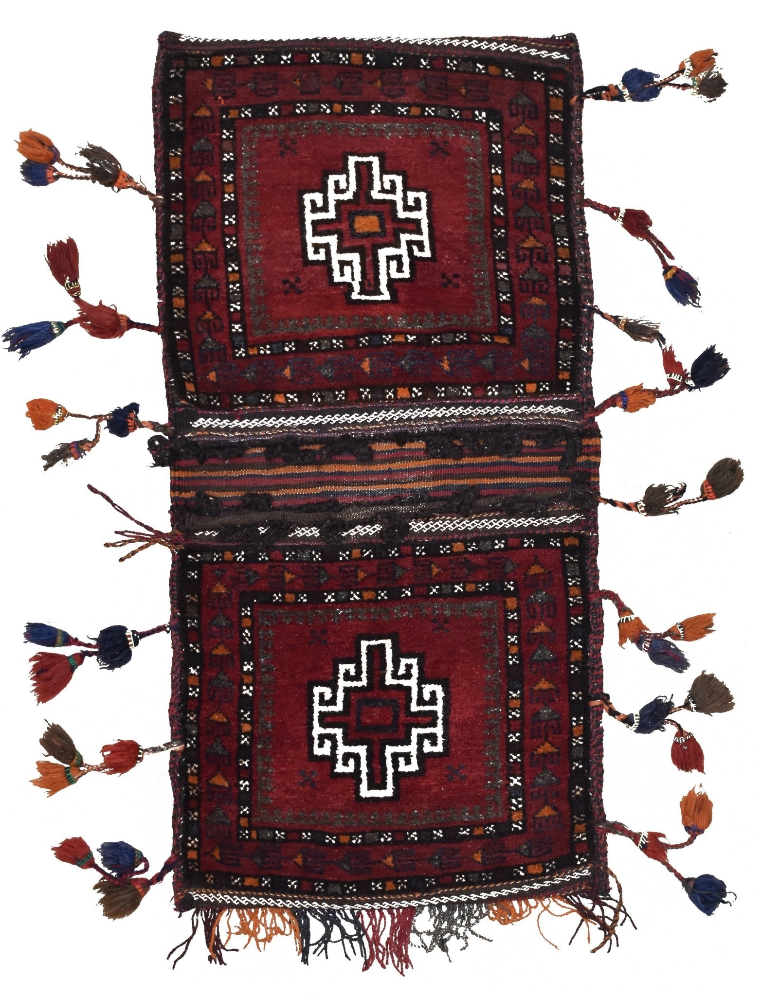 A handmade vintage Afghan wool saddle bag featuring two red panels with geometric white motifs.