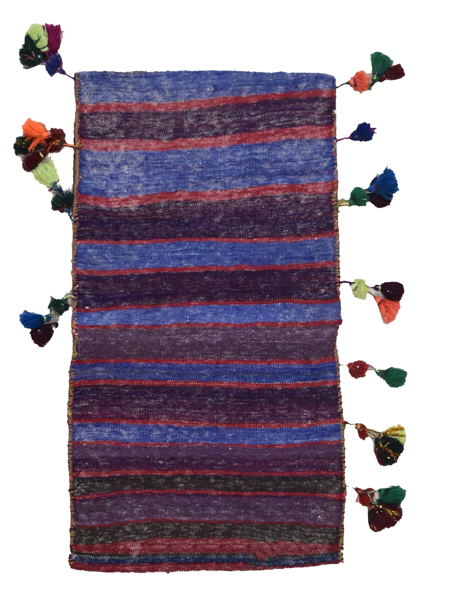 A vintage handmade Afghan wool saddle bag featuring horizontal stripes and decorative tassels.