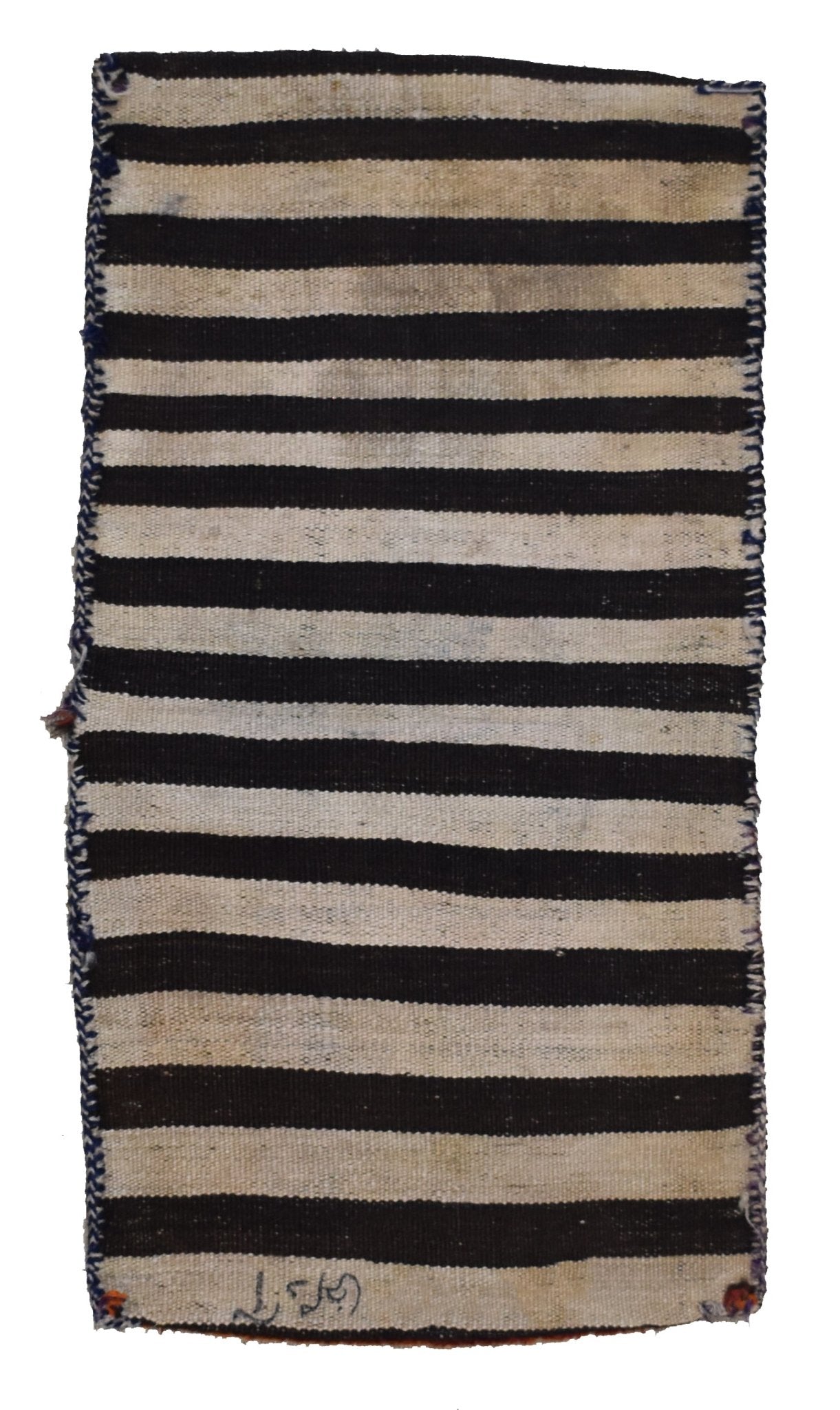 A vintage handmade Afghan saddle bag featuring a simple black and white striped wool pattern.