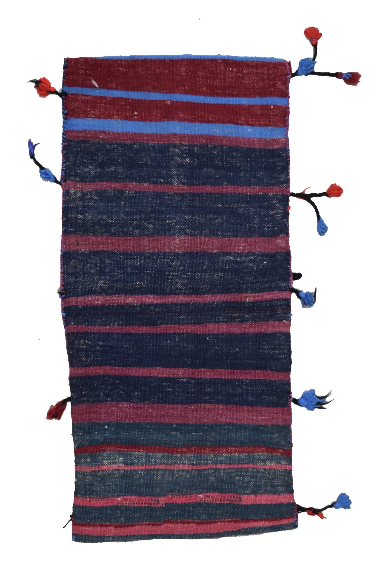 A handmade vintage Afghan wool saddle bag featuring horizontal stripes and decorative tassels.