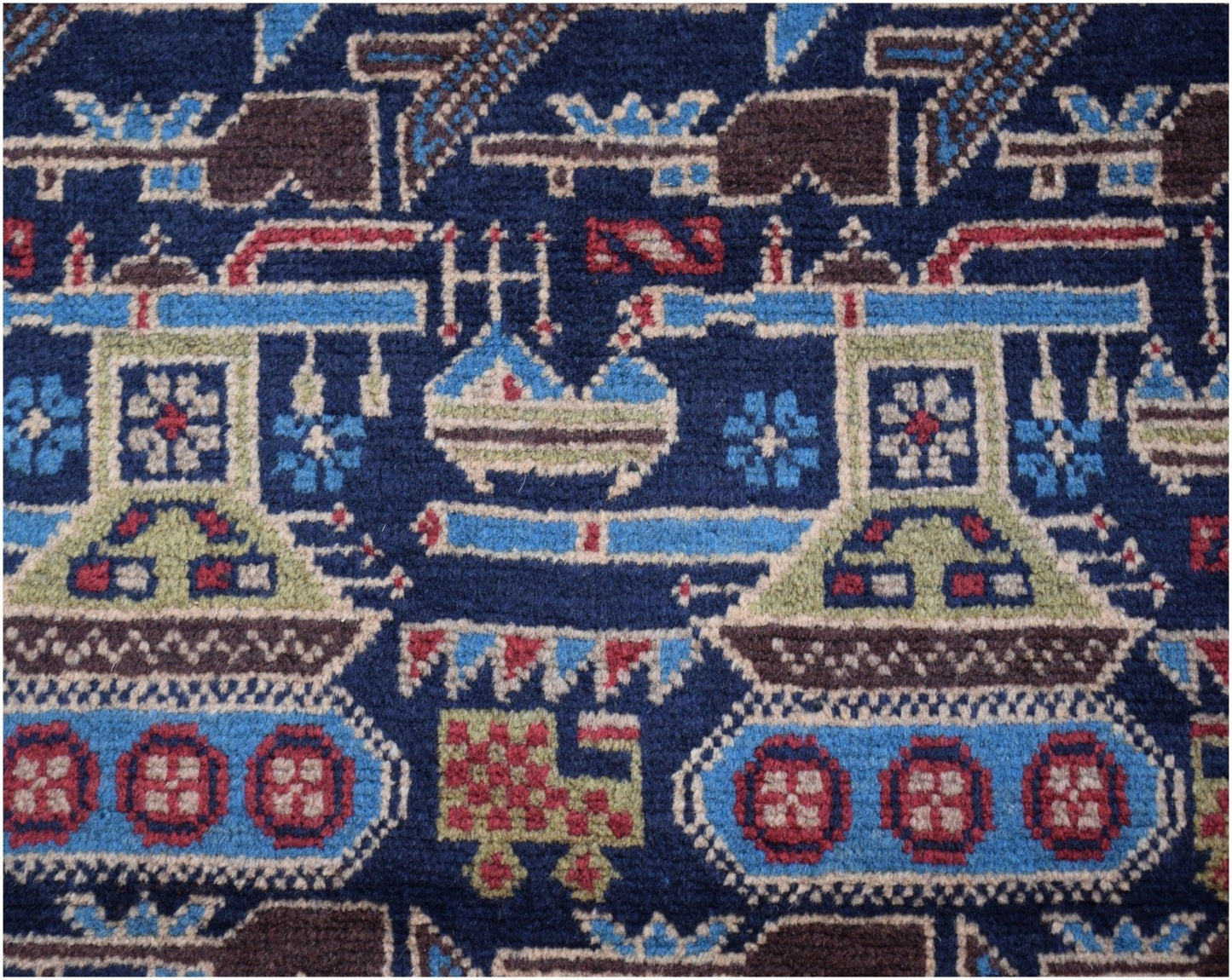 Handmade Afghan wool rug featuring a dark blue field with repeating tank and military motifs.