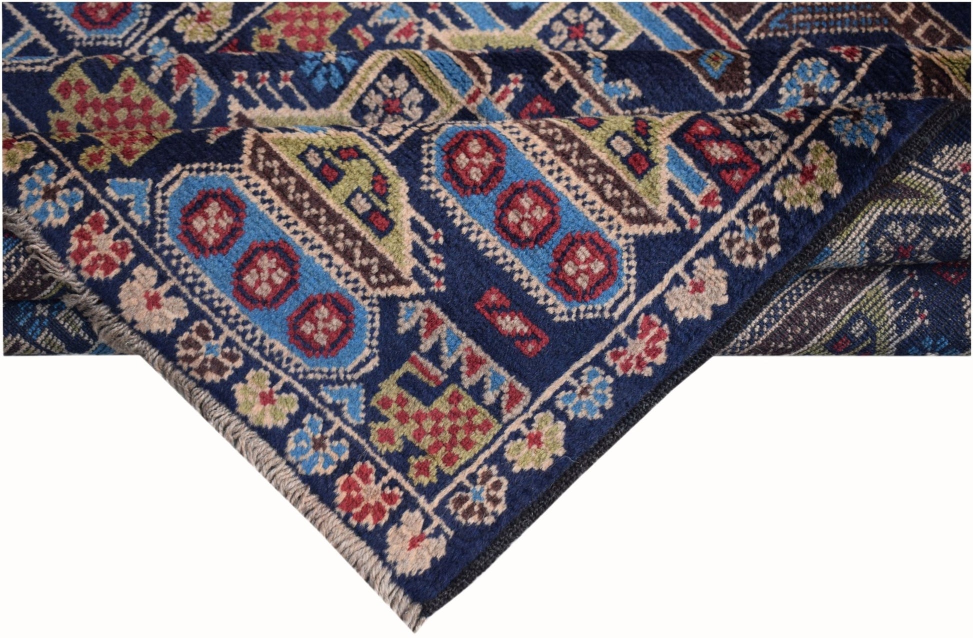 A handmade Afghan wool rug featuring traditional geometric patterns in blue, red, and green.