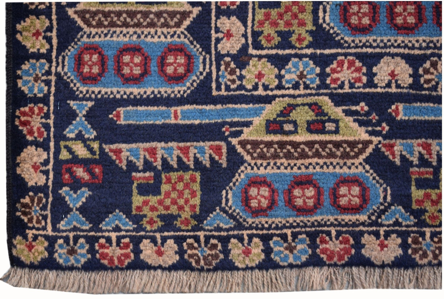 Handmade Afghan wool rug featuring a dark blue field with woven tank and military motifs.