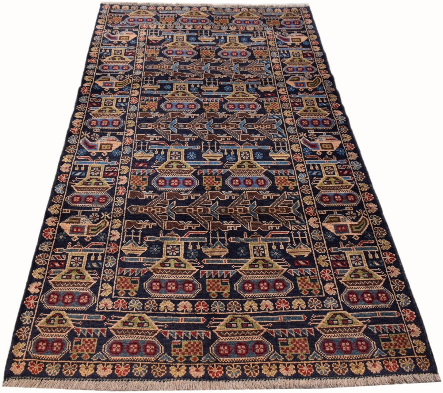 Handmade Afghan wool rug featuring a dark blue field with repeating tank and helicopter motifs.
