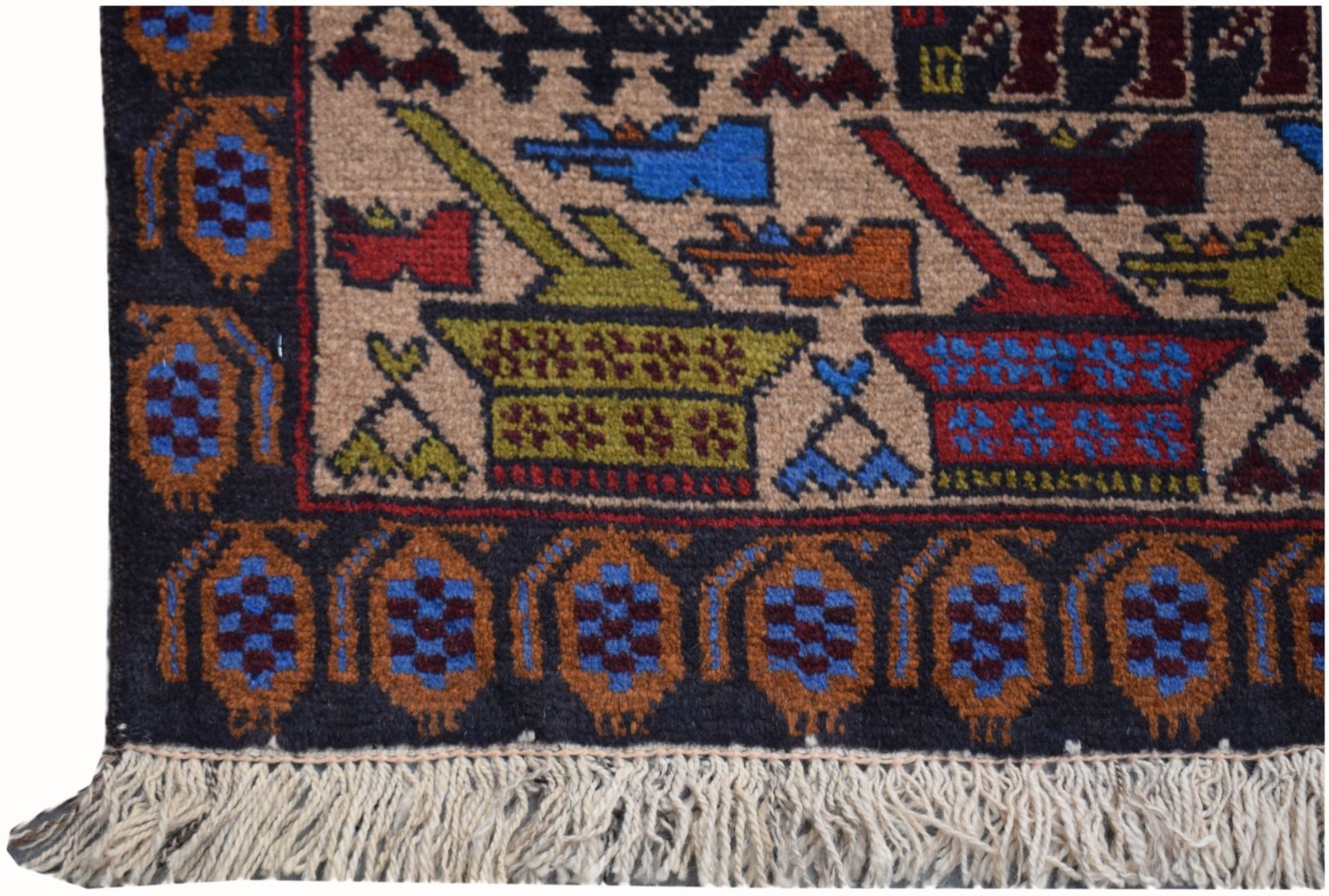 A handmade Afghan wool rug featuring a tan field with colorful motifs and a dark patterned border.