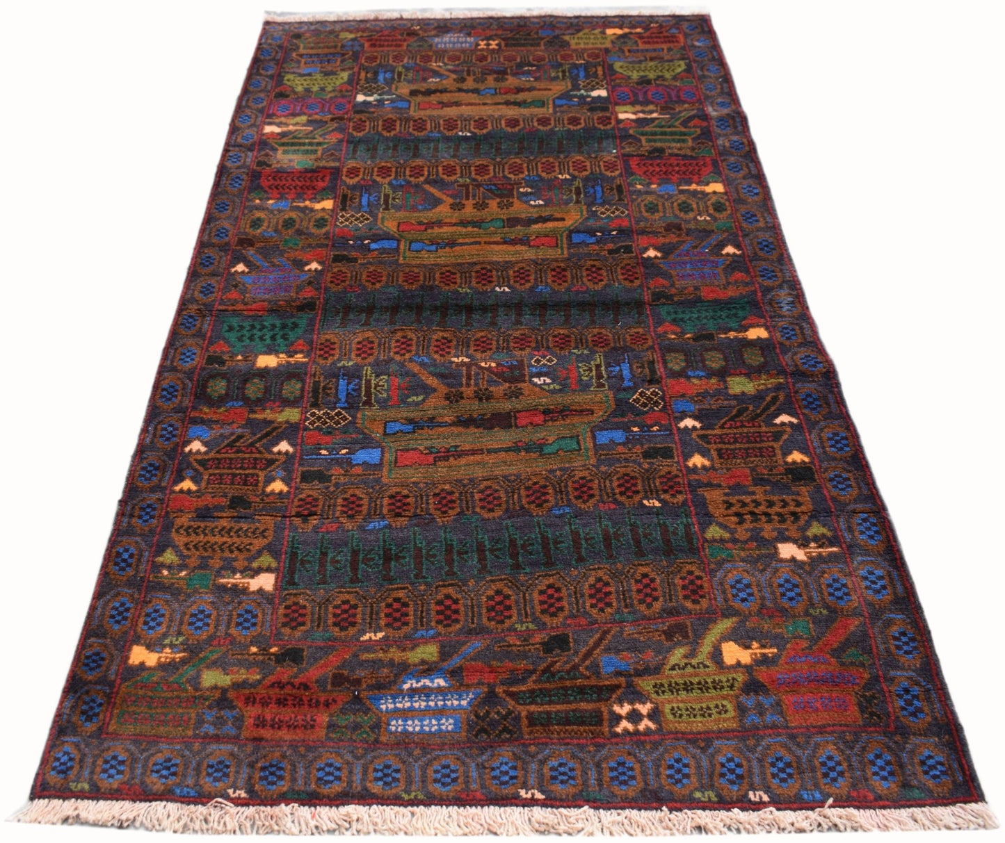 Handmade Afghan wool rug featuring a dark background with woven military tank and weapon motifs.