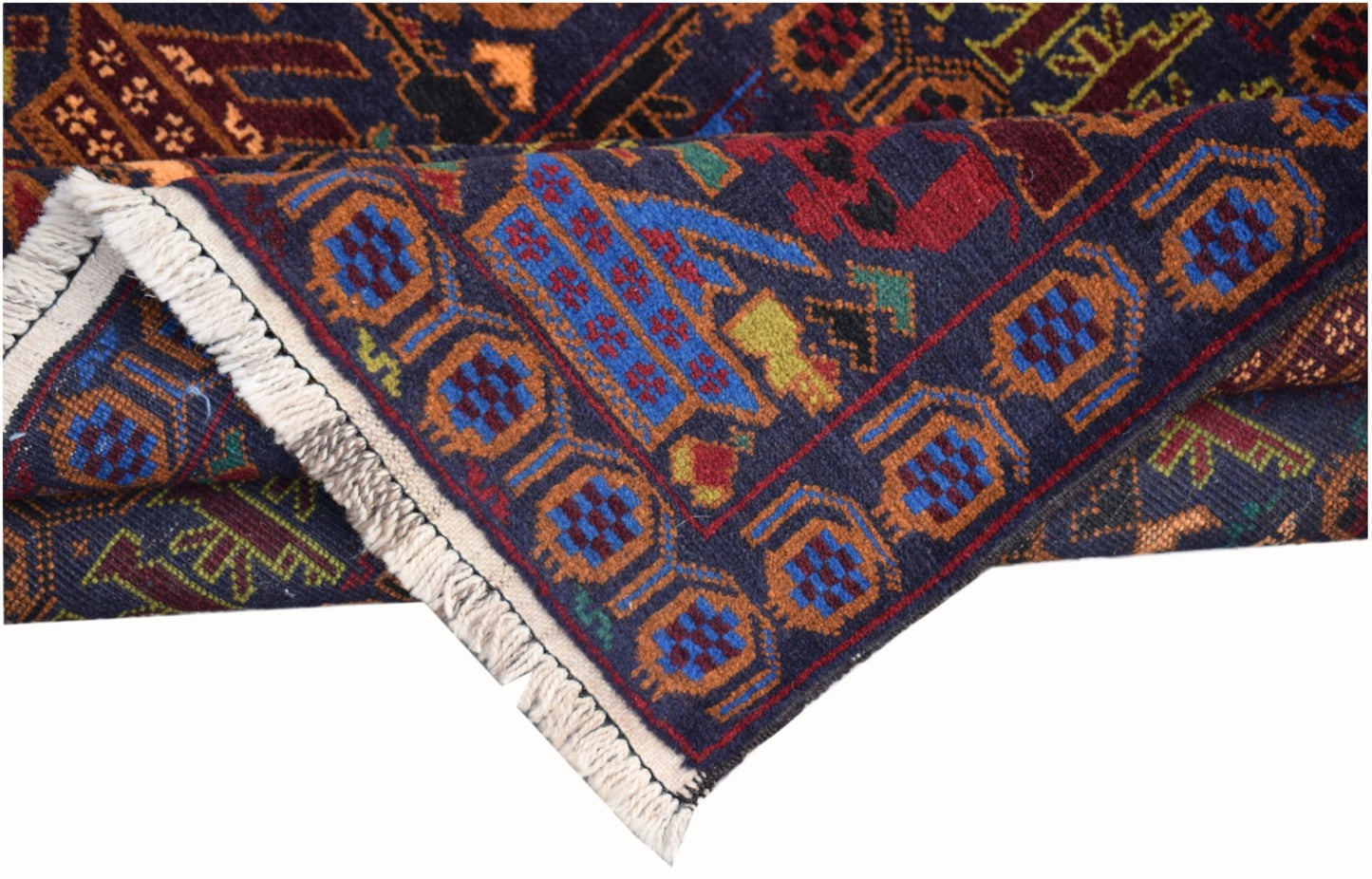 A handmade Afghan wool rug featuring geometric patterns and a dark blue background with fringe.