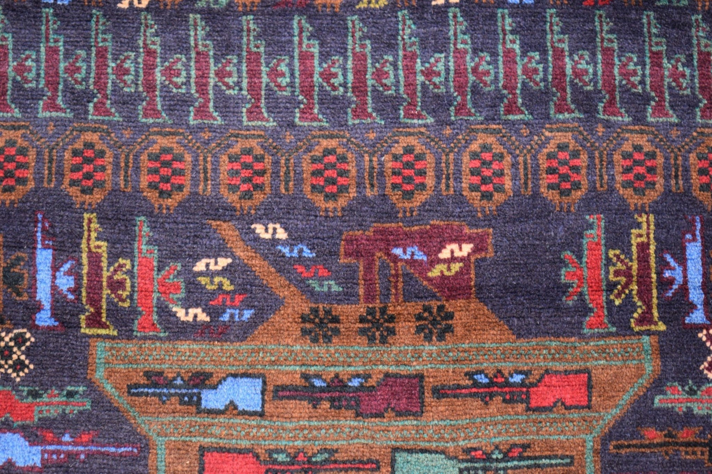 Handmade Afghan wool rug featuring intricate geometric patterns and military-themed motifs.