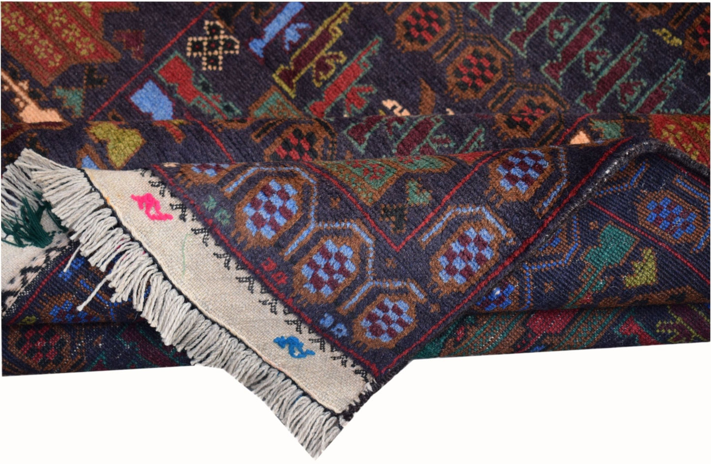 A handmade Afghan wool rug featuring a dark blue field with geometric patterns and fringe edges.