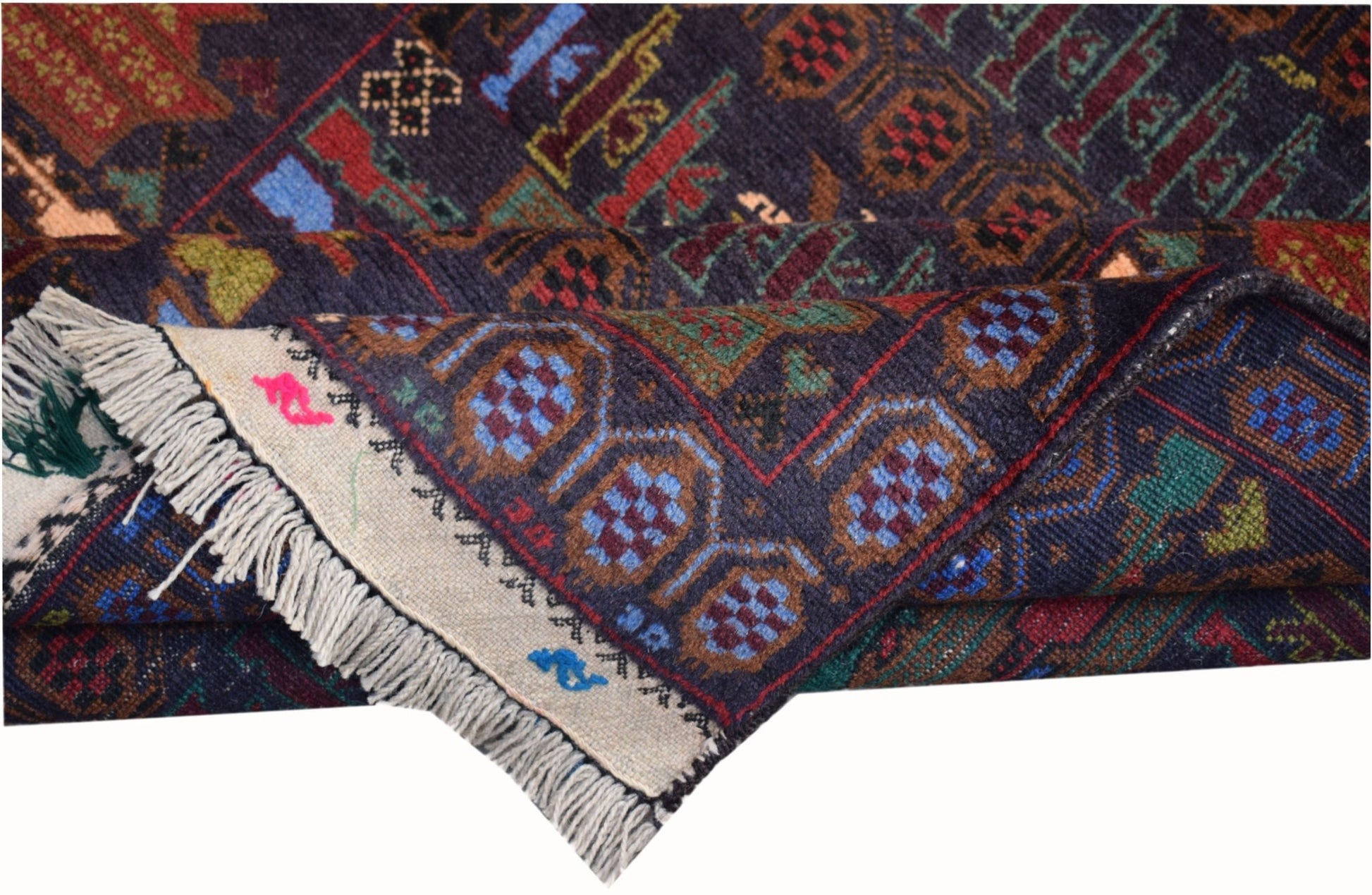 A handmade Afghan wool rug featuring a dark blue field with geometric patterns and fringe edges.