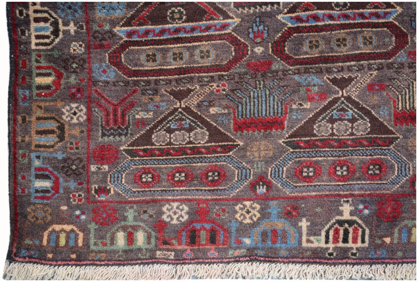 Handmade Afghan wool rug featuring a dark brown field with woven tank and military motifs.