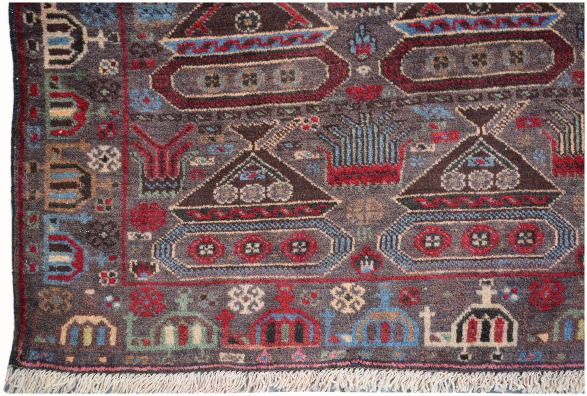 Handmade Afghan wool rug featuring a dark brown field with woven tank and military motifs.