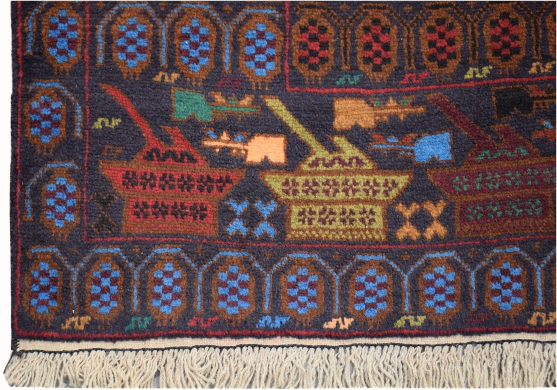Handmade Afghan wool rug featuring a dark field with tank motifs and geometric border patterns.