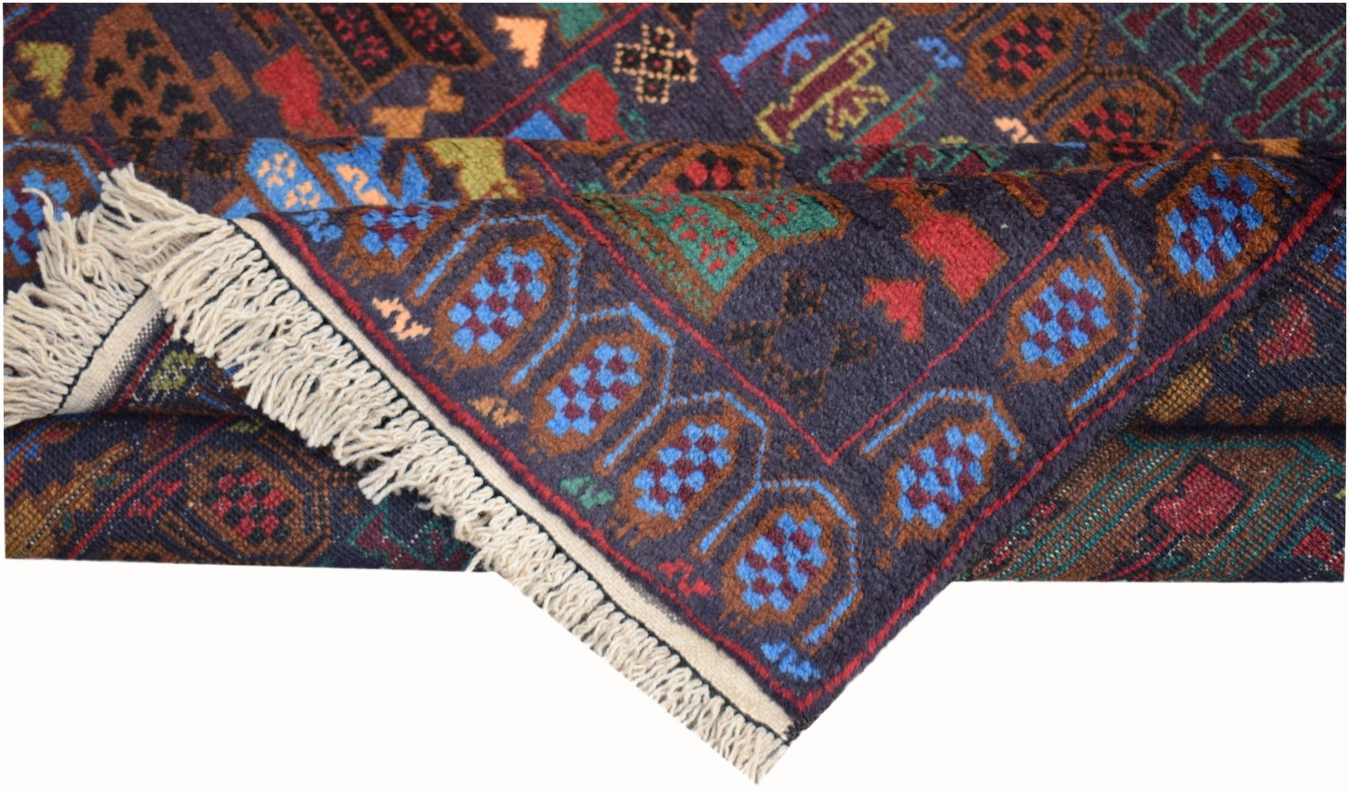 A handmade Afghan wool rug featuring a dark blue field with geometric patterns and fringe ends.