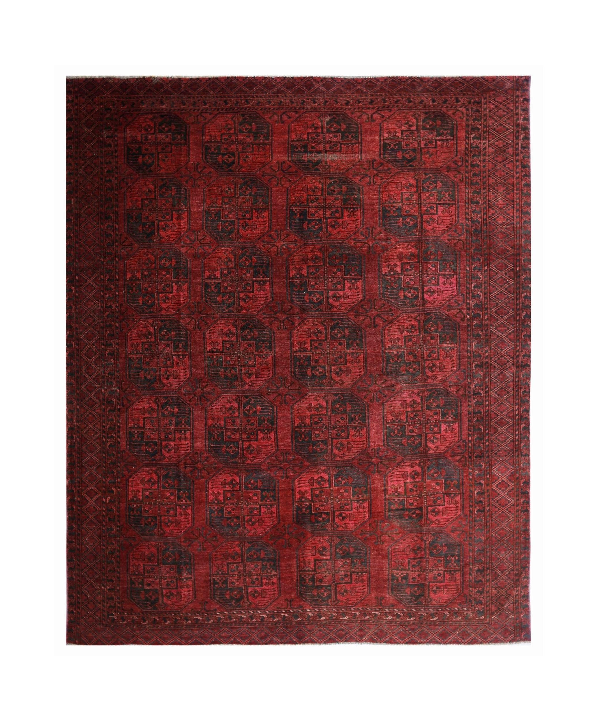 An antique Afghan Turkmen rug featuring repeating dark elephant foot motifs on a vibrant red field.