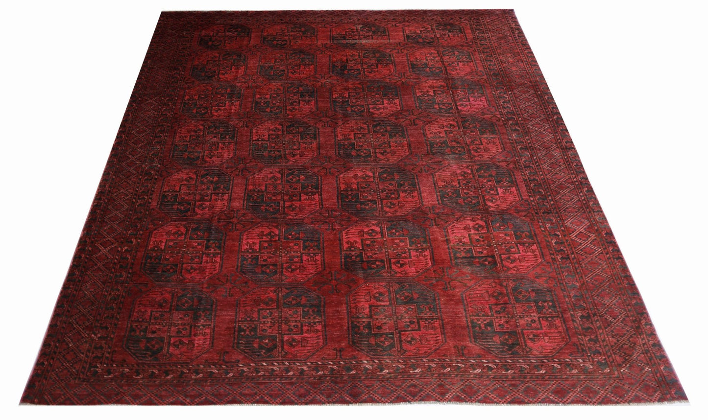 Handmade antique Afghan Turkmen rug featuring a repeating red and black elephant foot pattern.