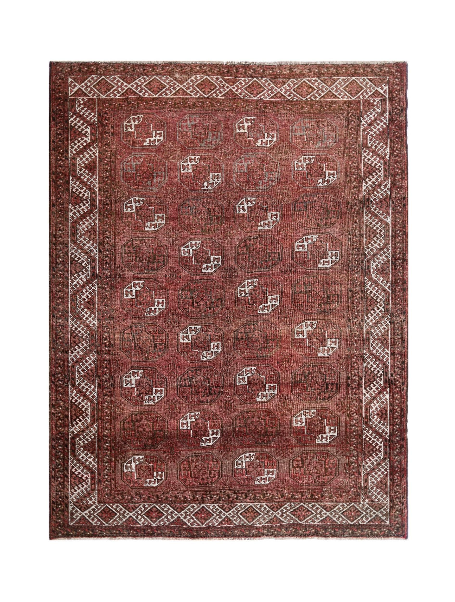 An antique Afghan Turkmen rug featuring repeating elephant foot motifs in red wool.