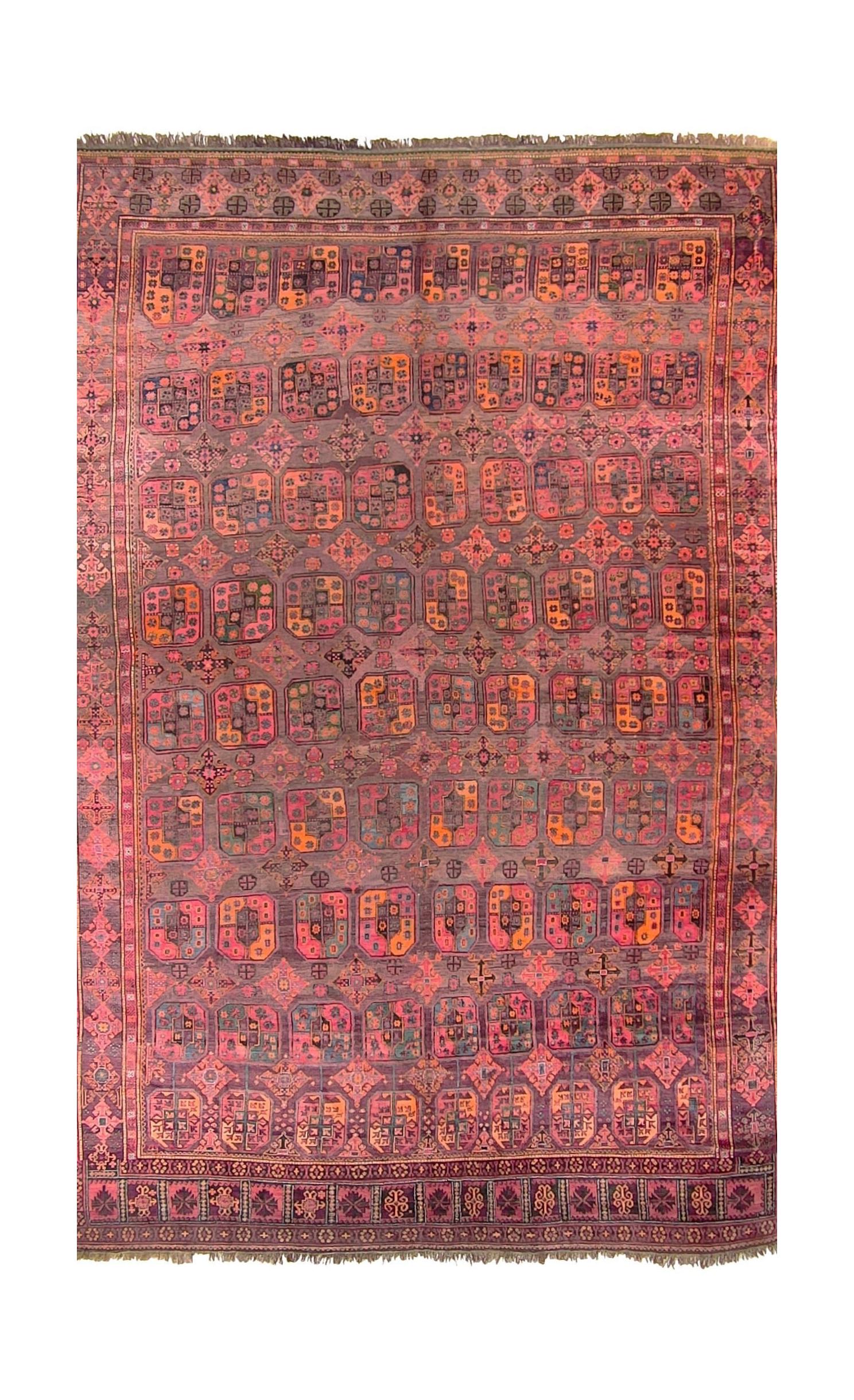 An antique Afghan Baluch rug featuring a repeating geometric pattern in deep red and brown tones.