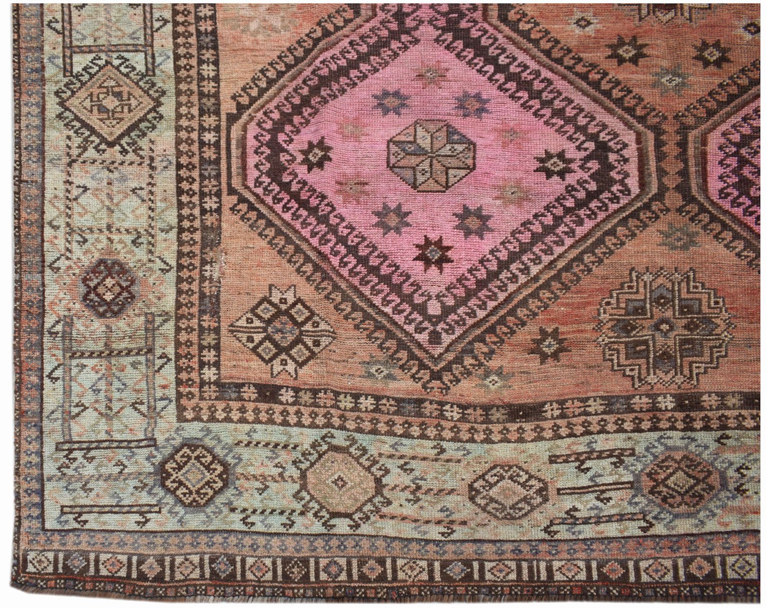 A vintage Persian Hamadan rug featuring a pink diamond medallion on a faded orange field.
