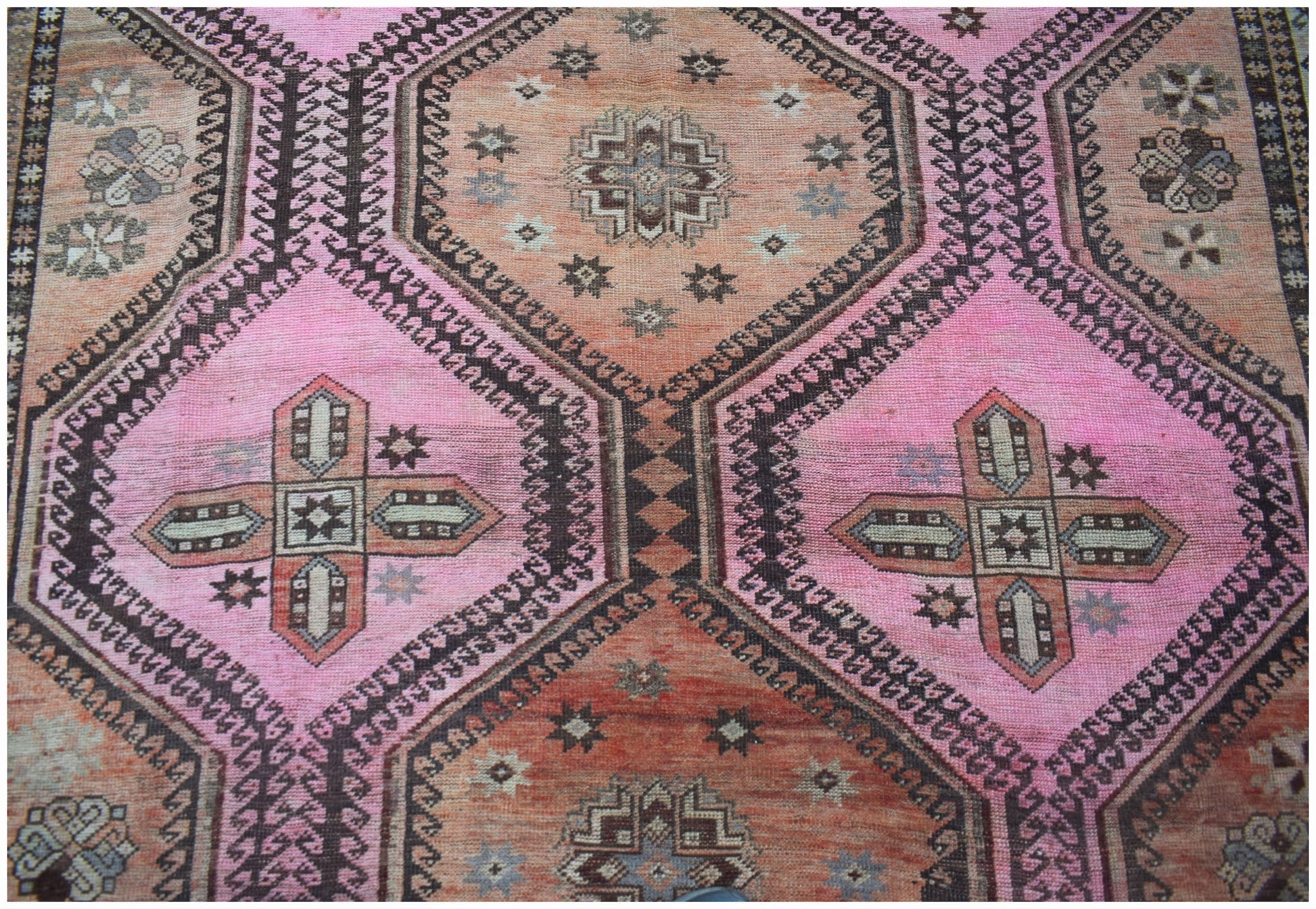 Vintage Persian Hamadan rug featuring a geometric pattern in shades of pink and orange.