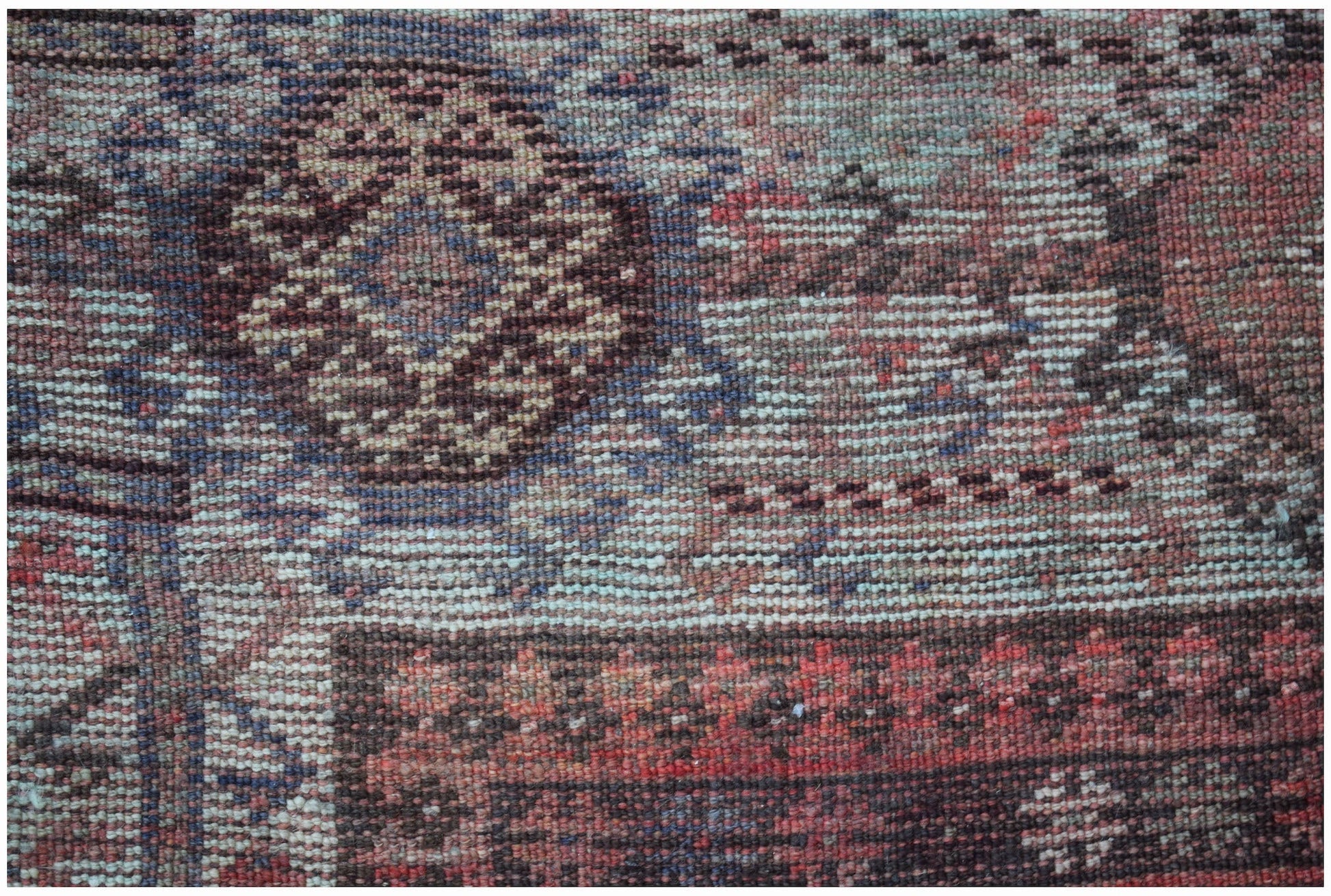 A close-up of a vintage handwoven Persian Hamadan rug featuring intricate geometric patterns.