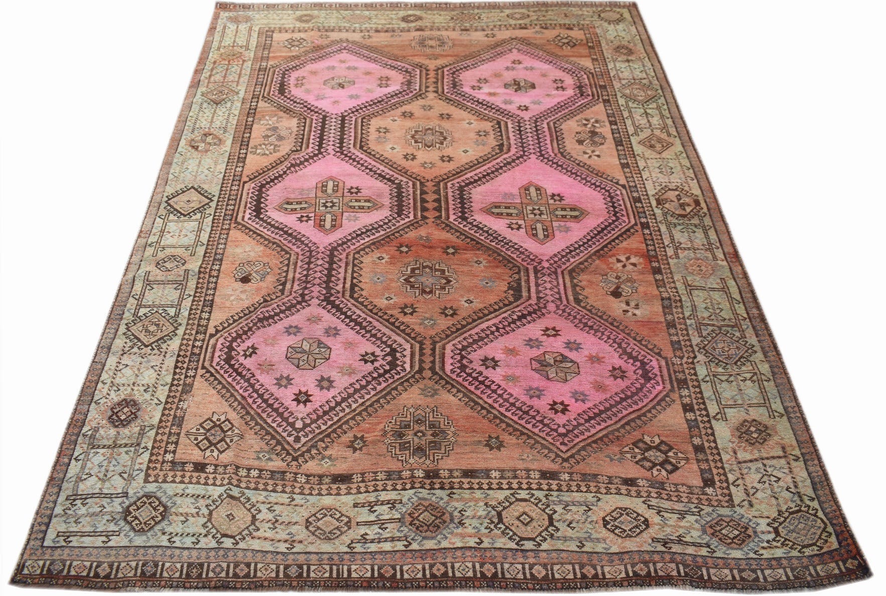 A vintage Persian Hamadan rug featuring pink and orange geometric medallions on a patterned field.