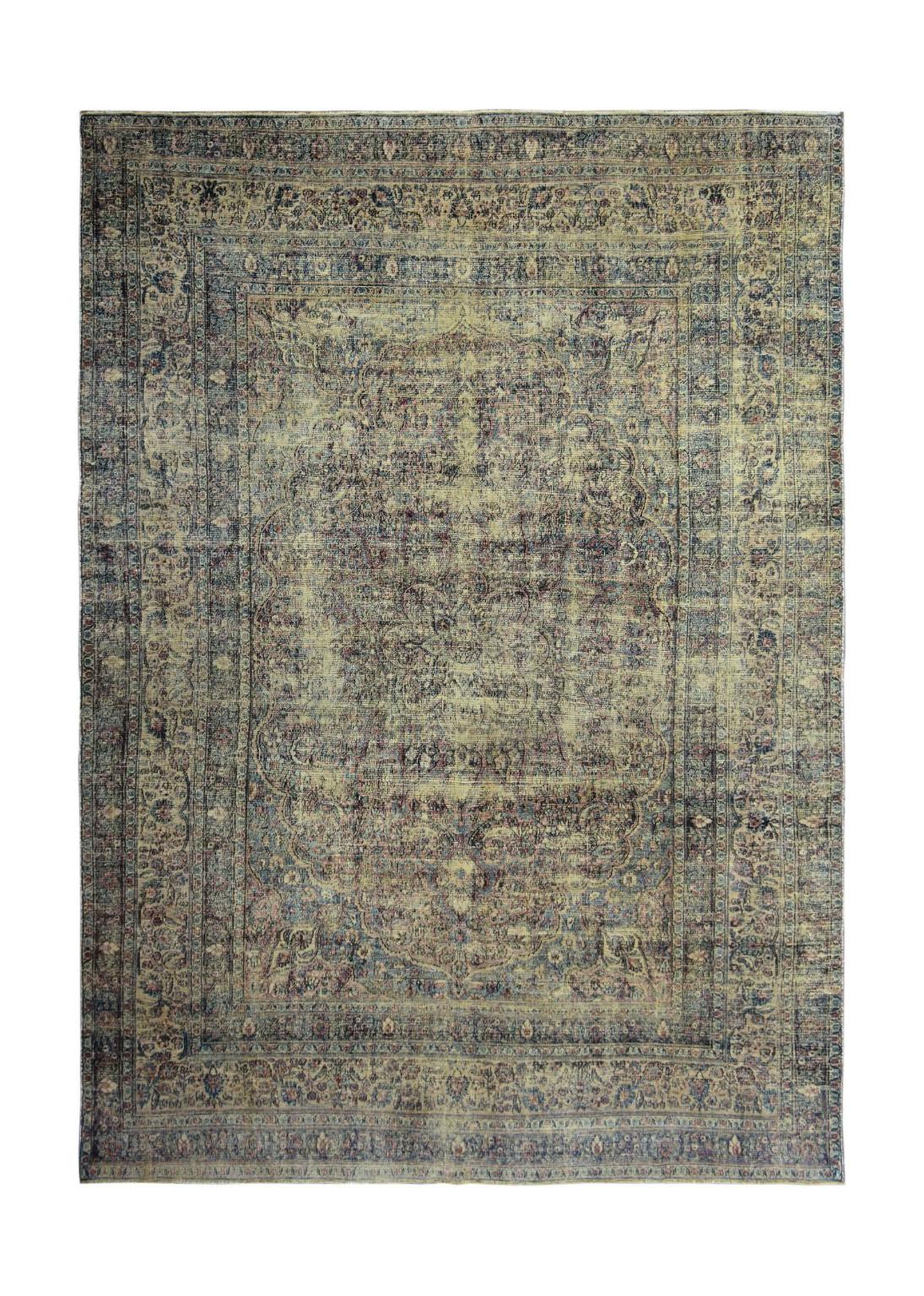 An antique Persian Kerman rug featuring a central medallion and intricate floral patterns.
