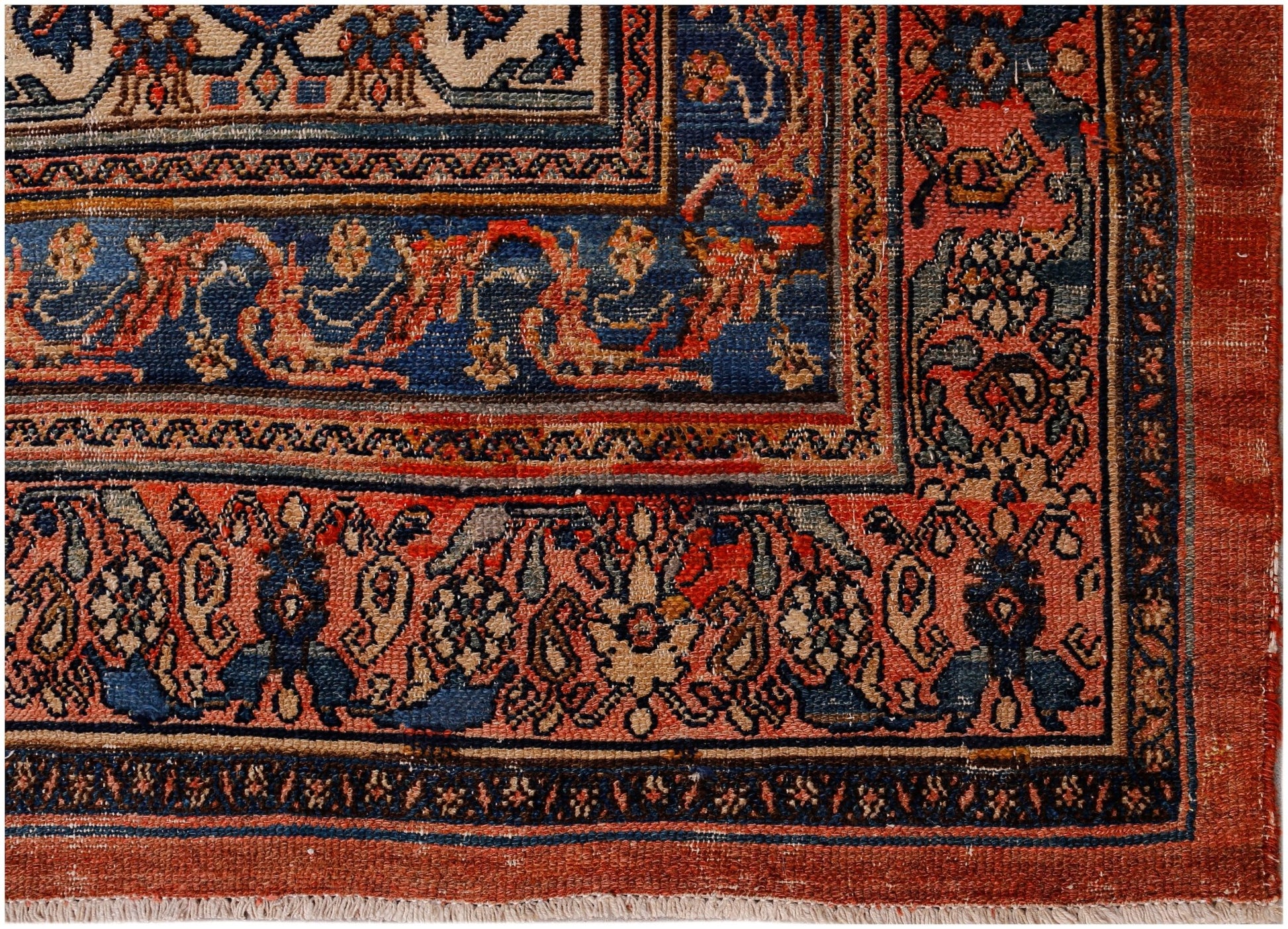 An antique Persian Senneh rug featuring intricate floral patterns in red, blue, and cream tones.