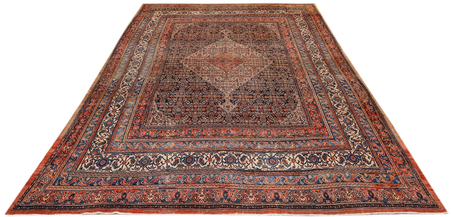 An antique Persian Senneh rug featuring a central medallion on a dark floral field.
