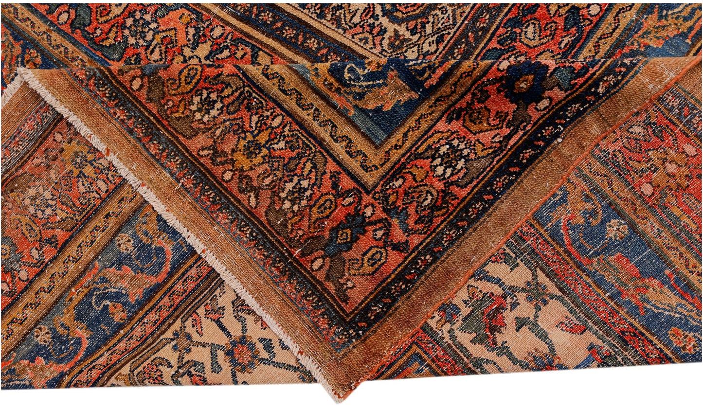 An antique Persian Senneh rug featuring intricate floral patterns in red, blue, and cream tones.