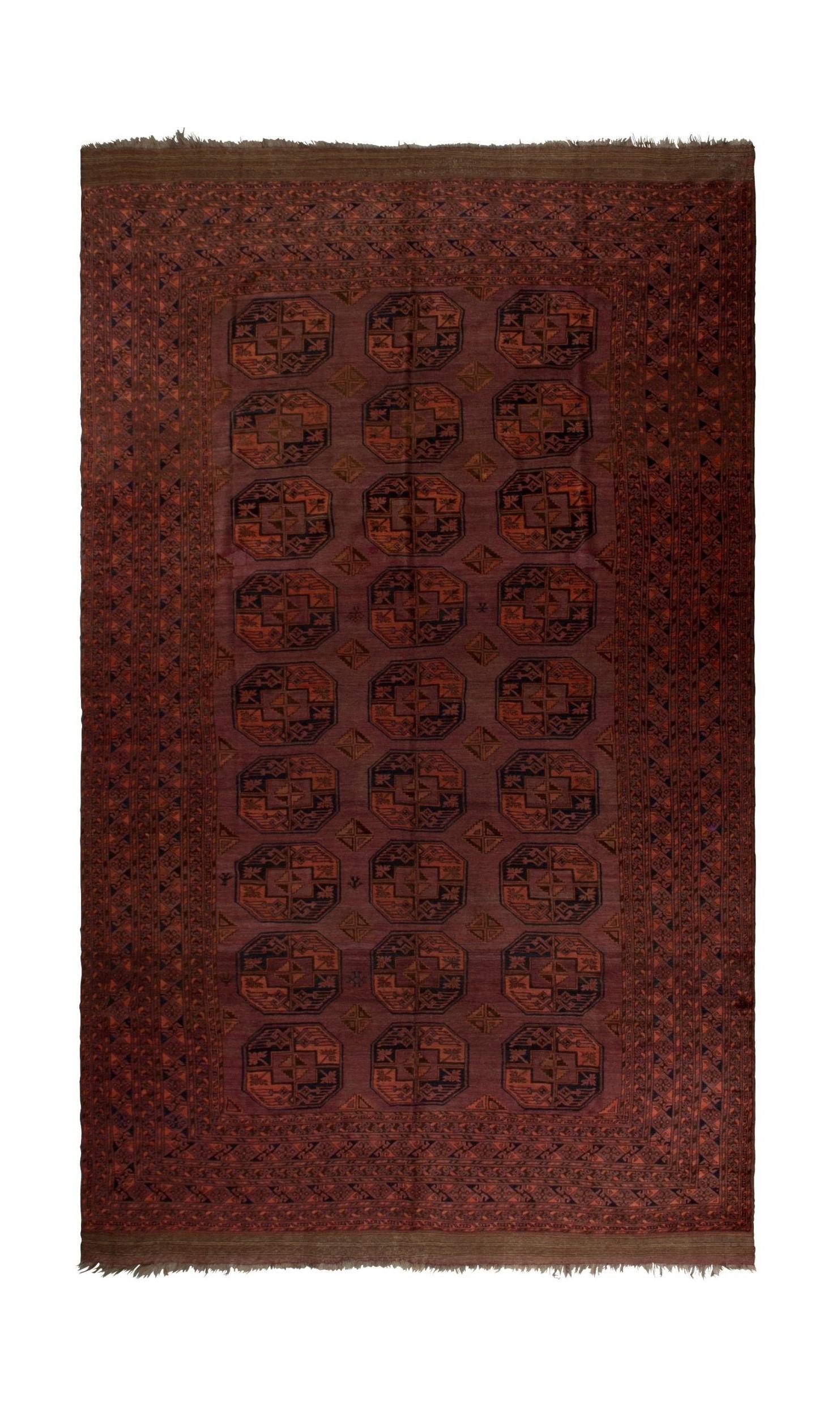 An antique Afghan Turkmen rug featuring a repeating geometric octagonal pattern in deep red tones.