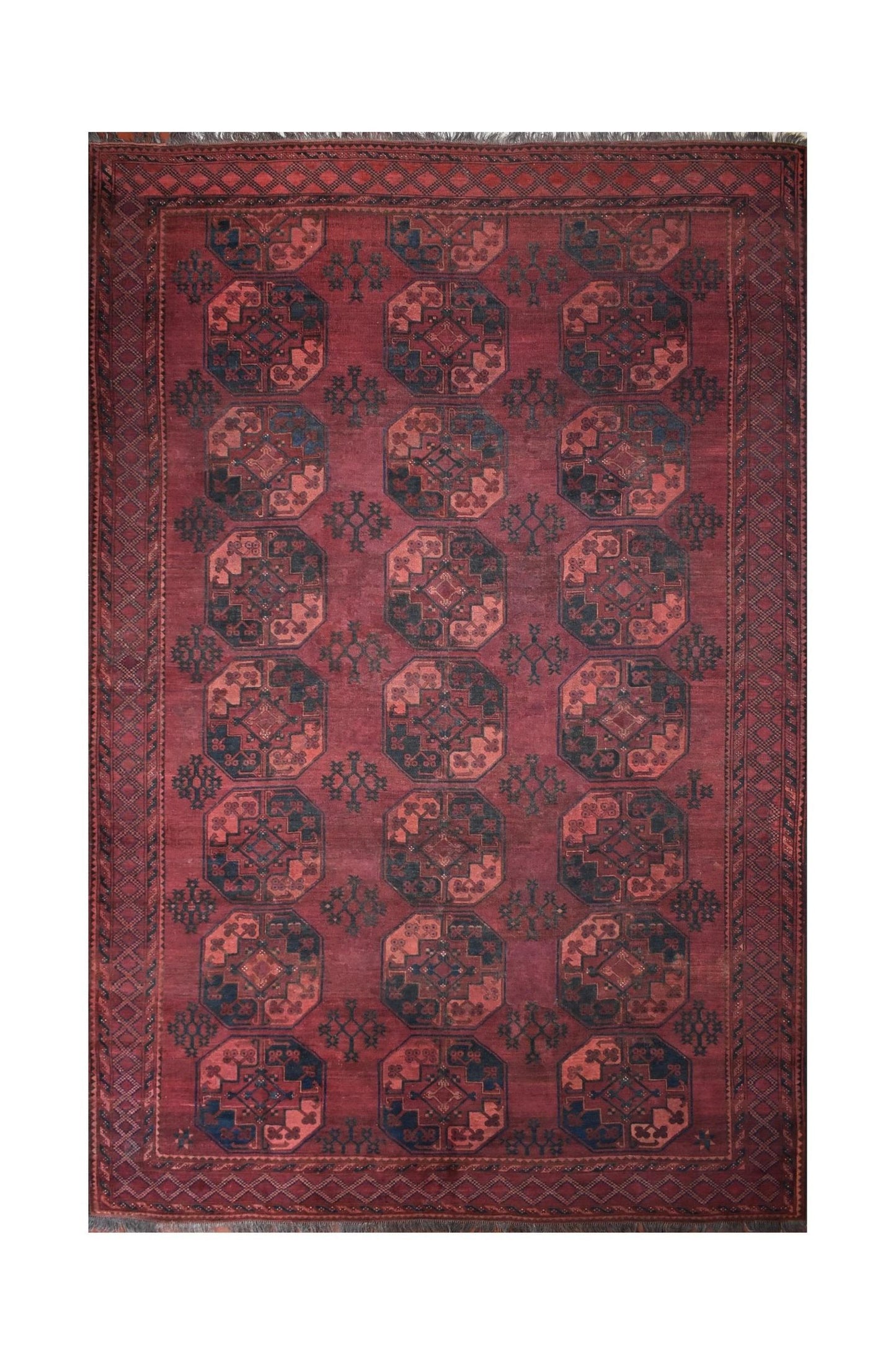 An antique Afghan Turkmen rug featuring a repeating geometric octagonal pattern in deep red wool.