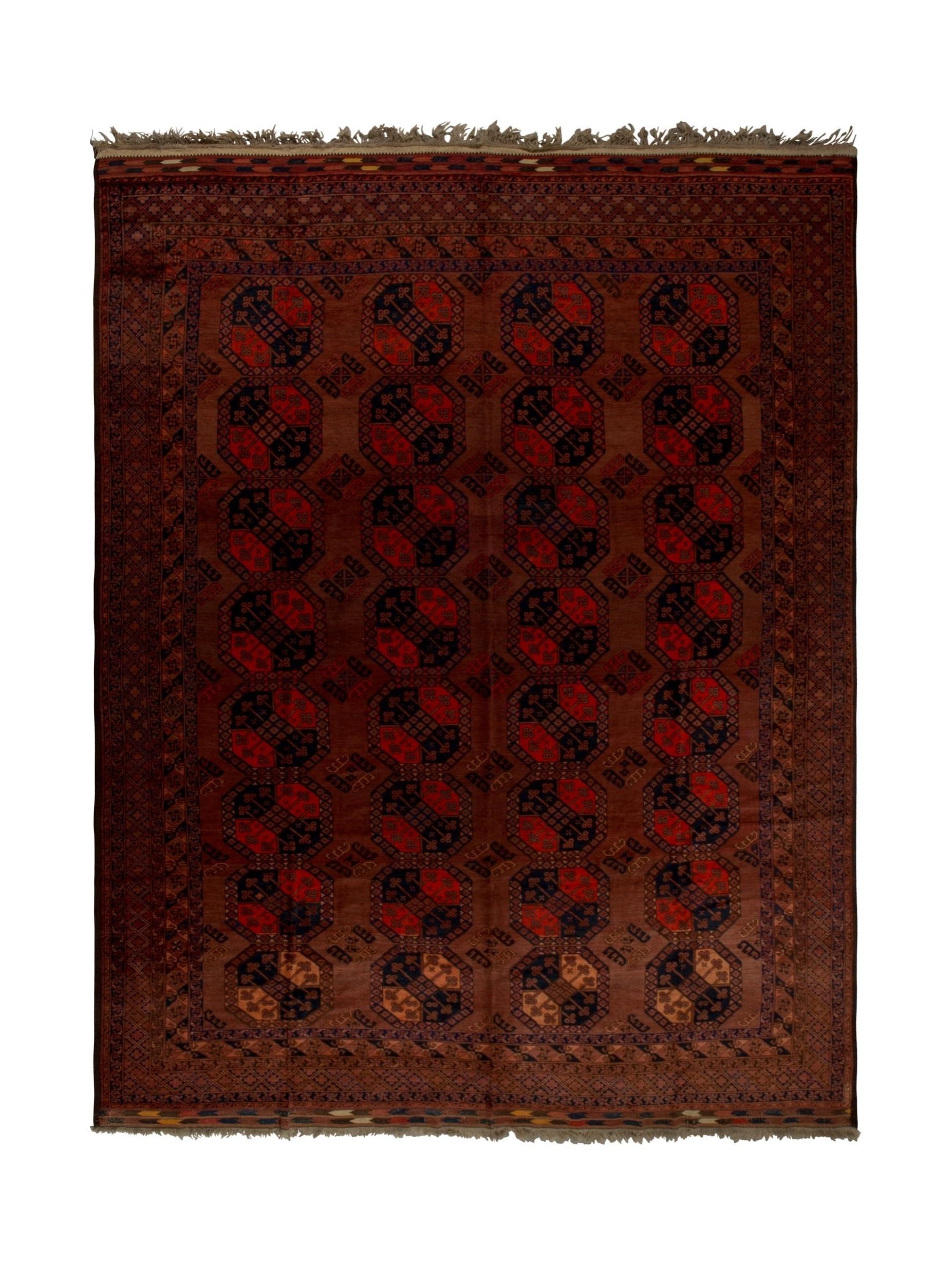 An antique handmade Afghan Turkmen wool rug featuring a repeating geometric pattern in deep red.