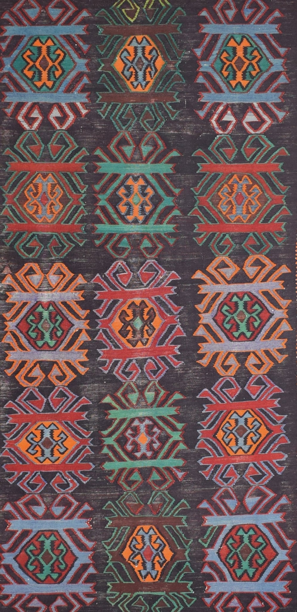 A vintage Caucasian Karabagh kilim featuring a repeating geometric pattern in vibrant wool colors.