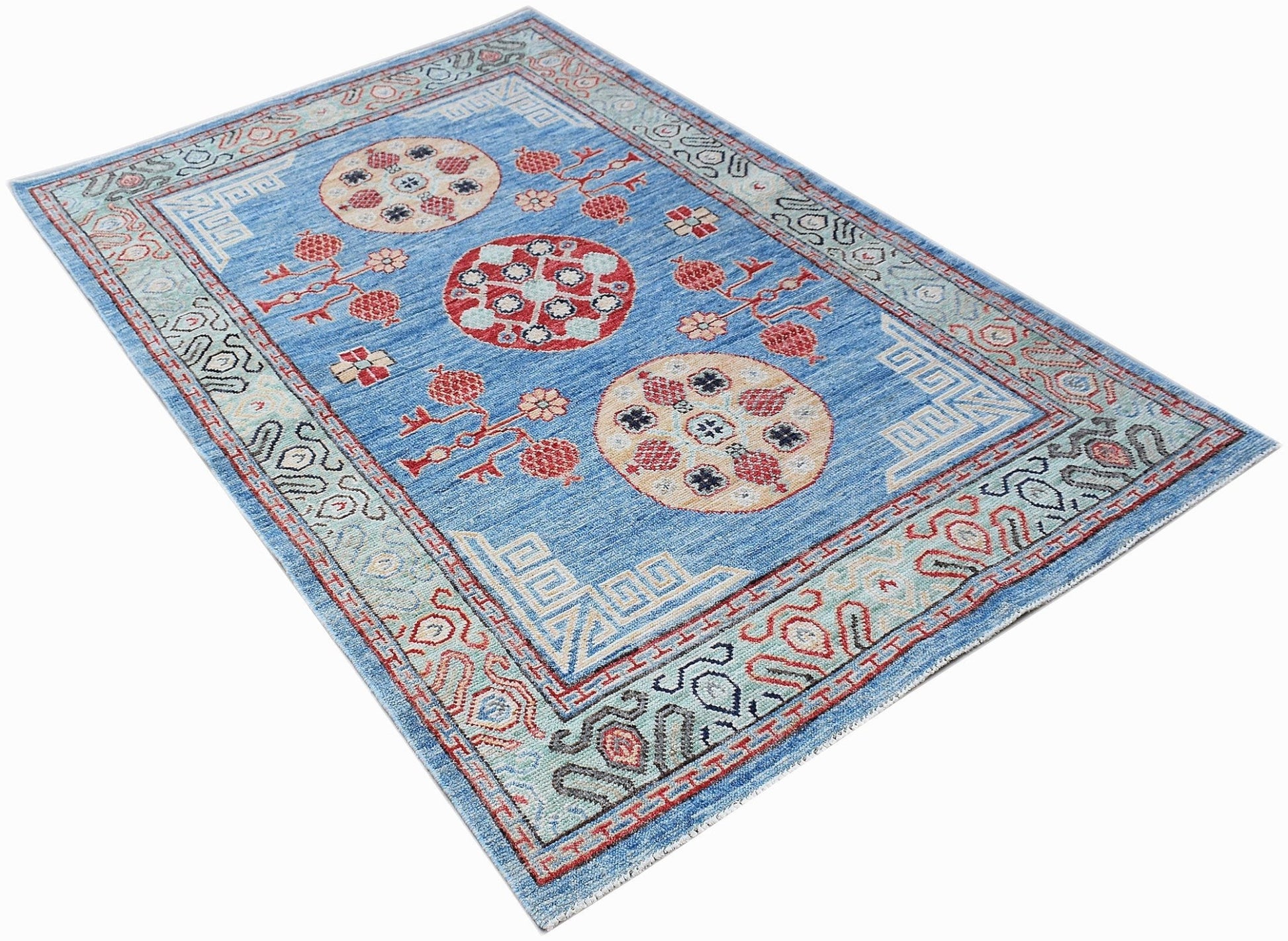 A rectangular Afghan Chobi rug in blue with traditional circular motifs and geometric borders.