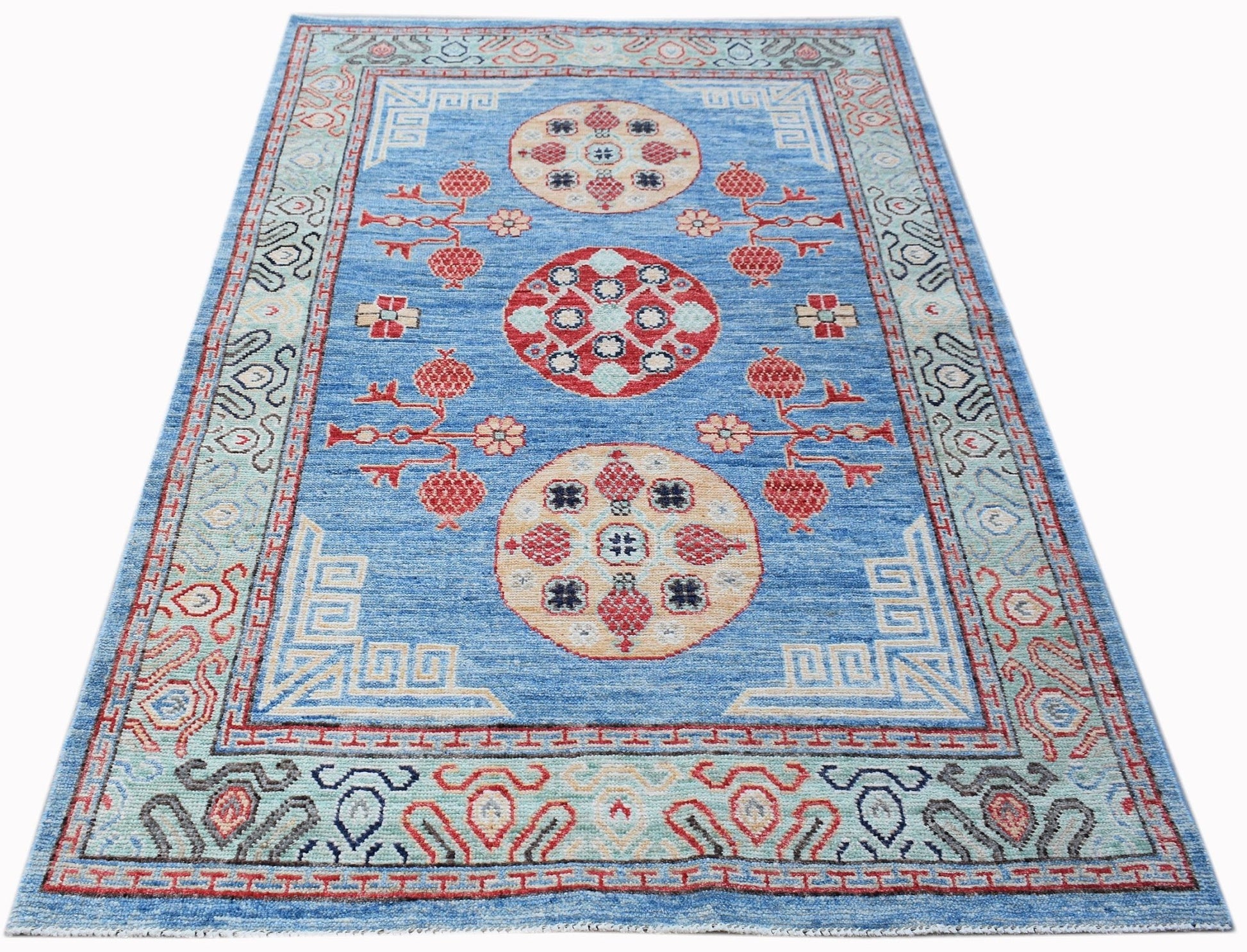 A rectangular Afghan Chobi rug featuring three circular medallions on a blue field.