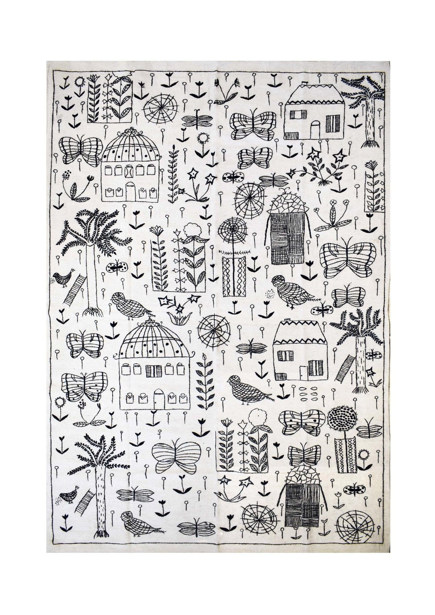 Handmade wool kilim featuring black embroidered botanical and architectural motifs on a white base.