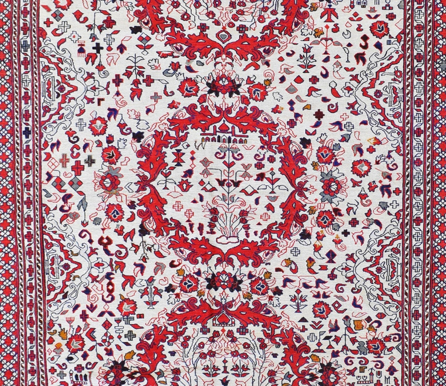 A vintage Afghan Sumak kilim featuring intricate red and white geometric floral patterns.